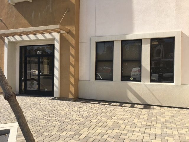 A building with a lot of windows and a tree in front of it