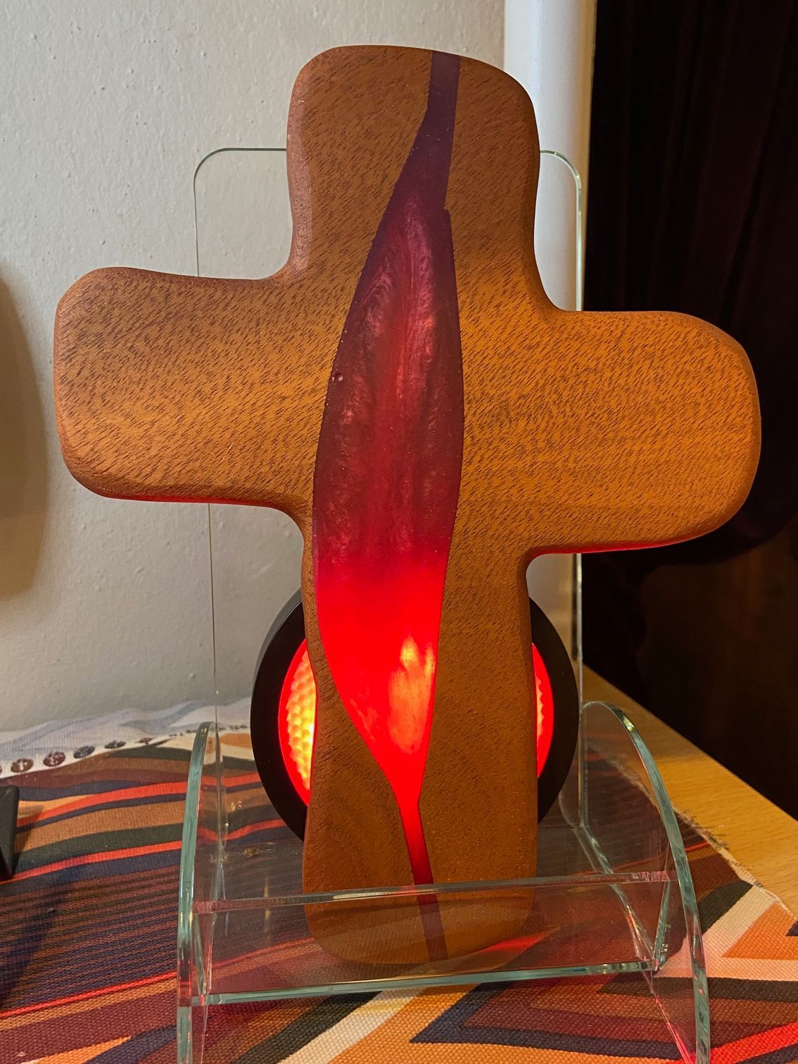 A gingerbread cross with a red candle inside of it