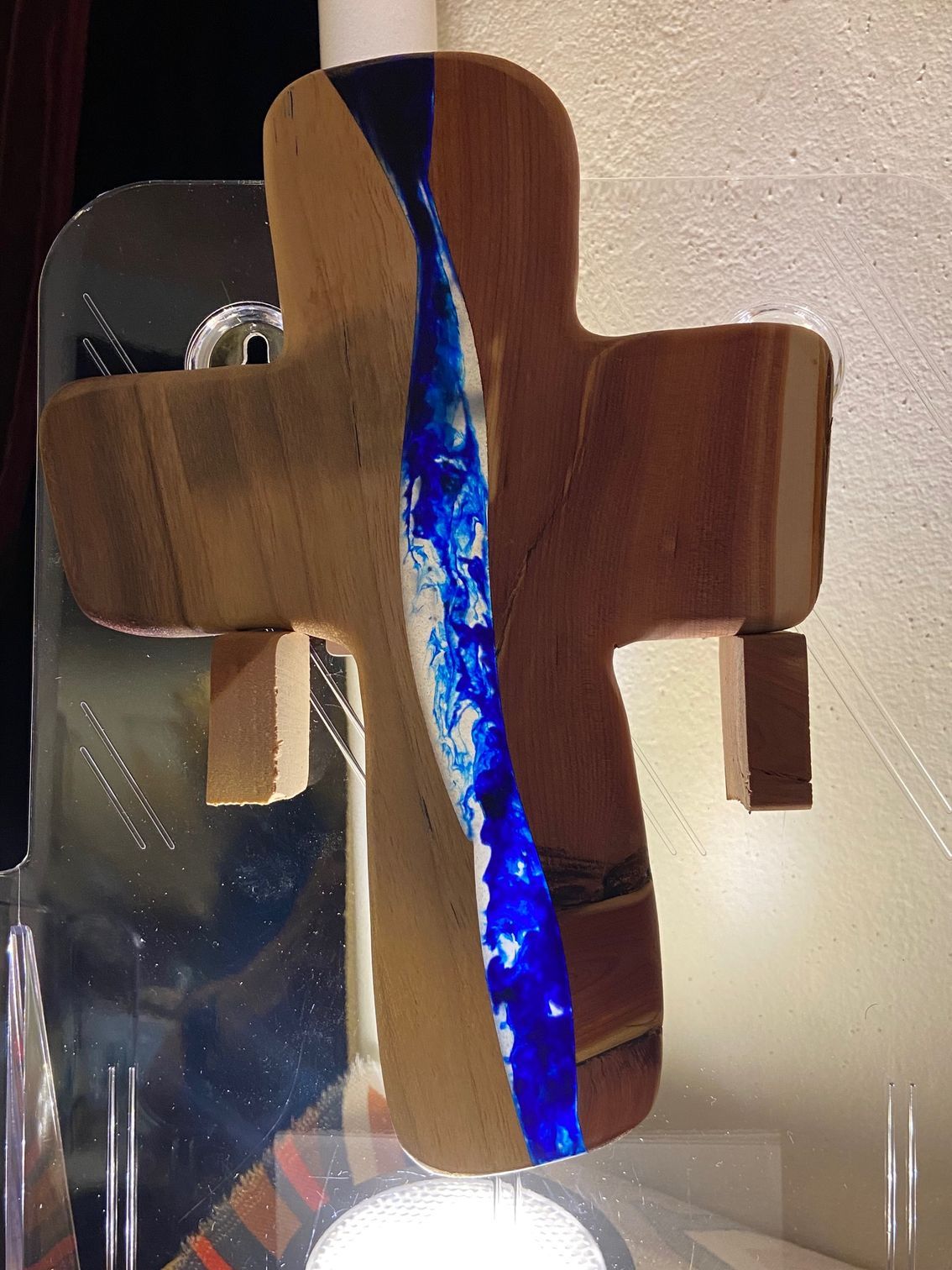 A wooden cross with a blue stripe on it