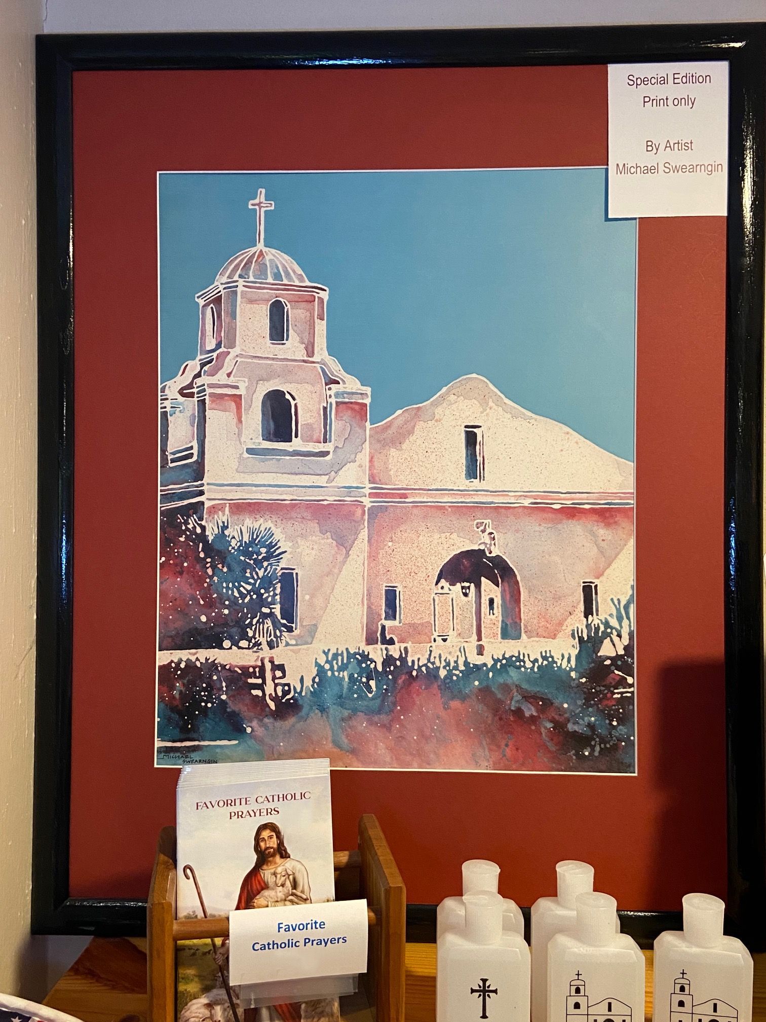A framed picture of a church with a cross on top