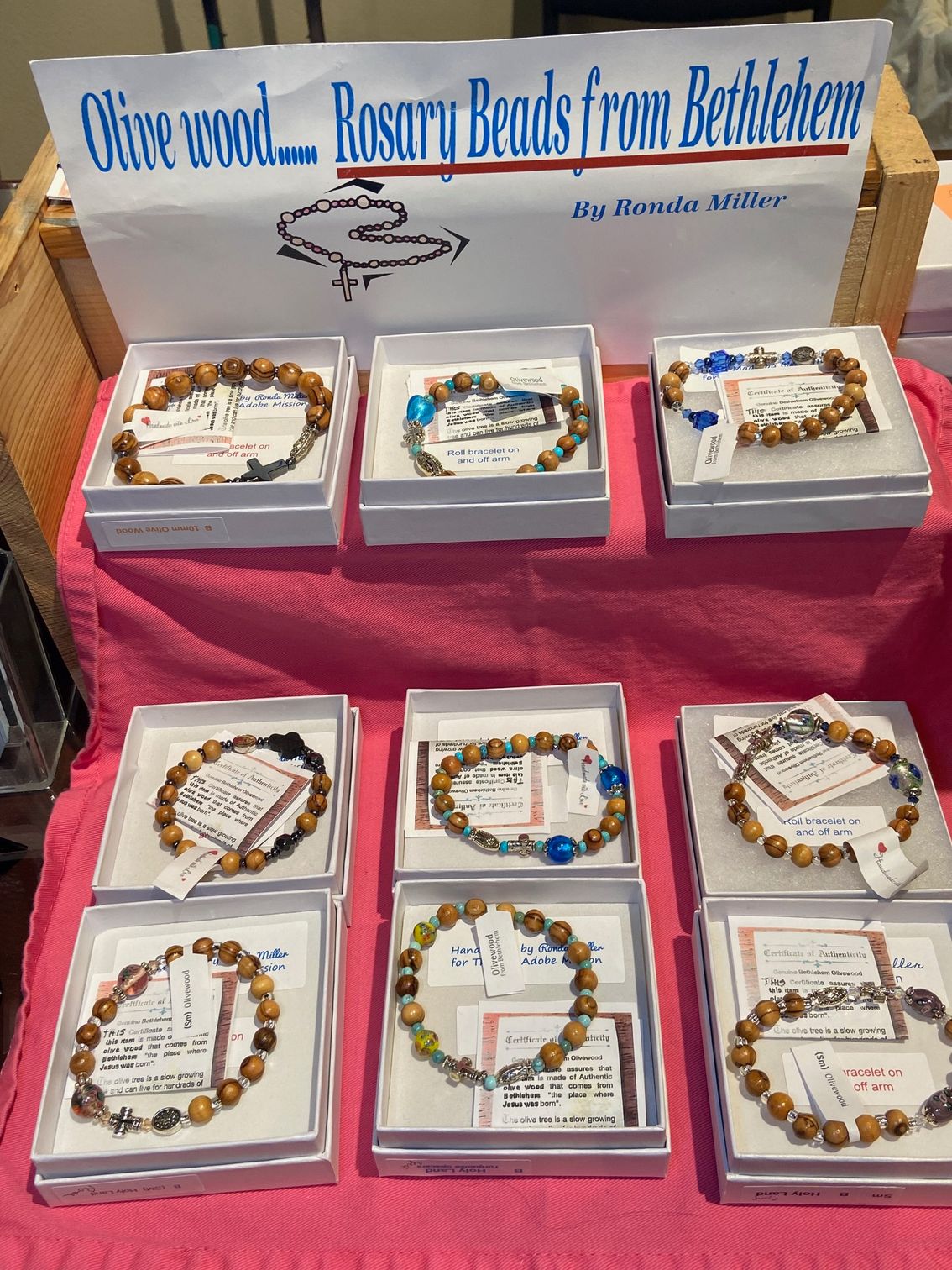 A table with boxes of rosary beads on it