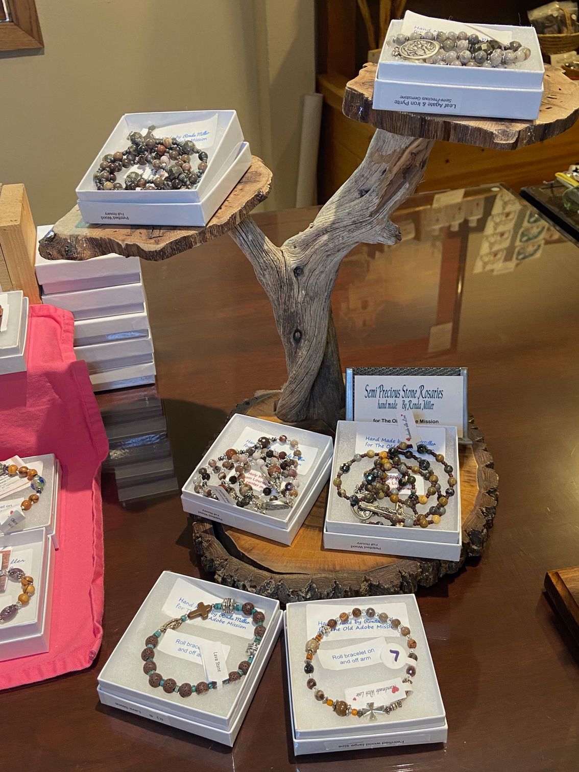 A display of bracelets and necklaces on a wooden table