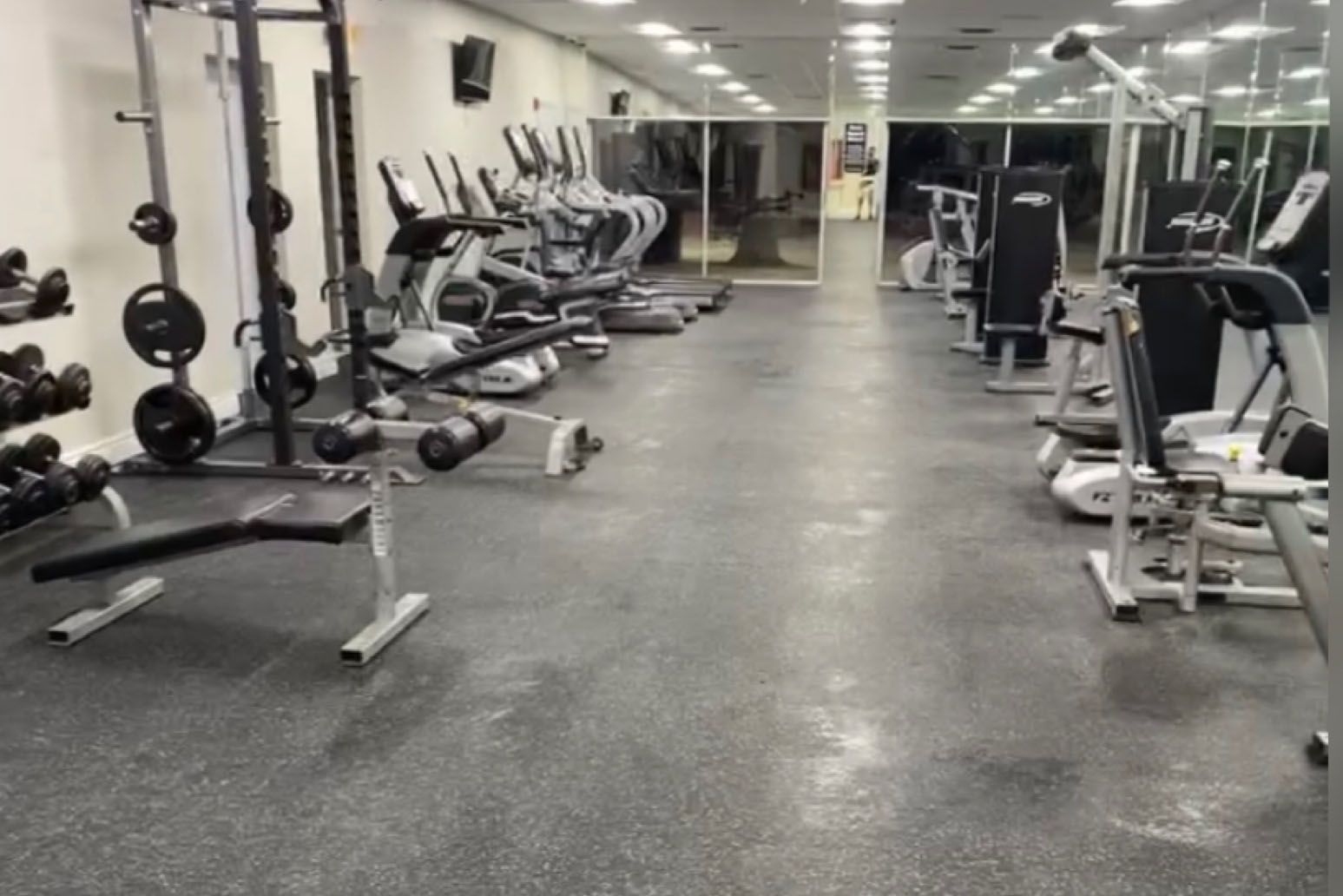 A large gym filled with lots of exercise equipment