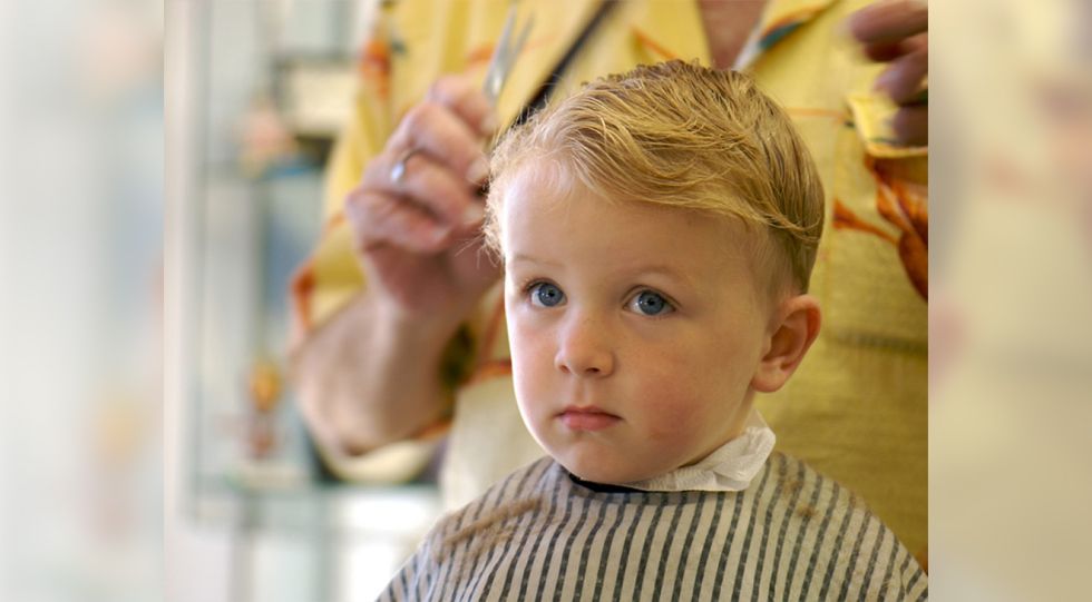 A barber cutting a child's hair