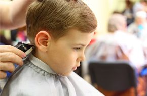 A barber cutting a child's hair