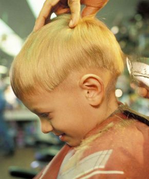 a boy getting his hari cut