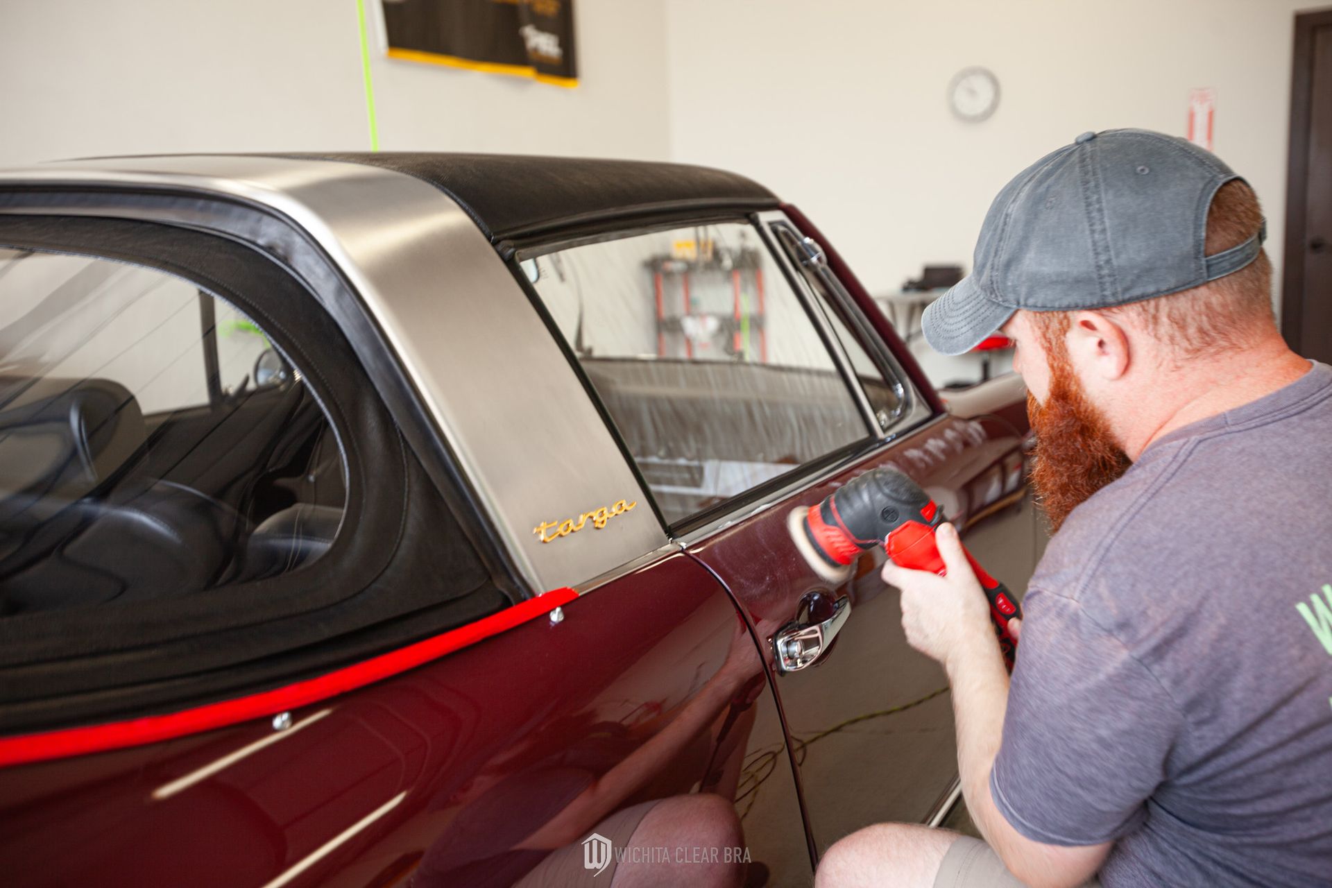 Detailer performing a two-step paint correction on the driver's side of a 1968 Porsche 911 Targa to restore gloss and remove paint imperfections.