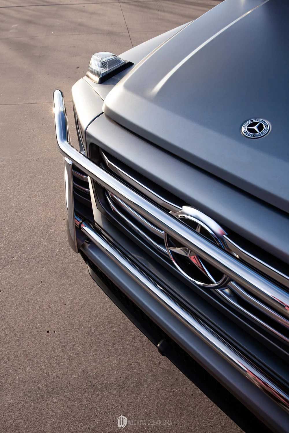 Gray Mercedes-Benz G-Wagon front end with a chrome bumper and the Mercedes logo.