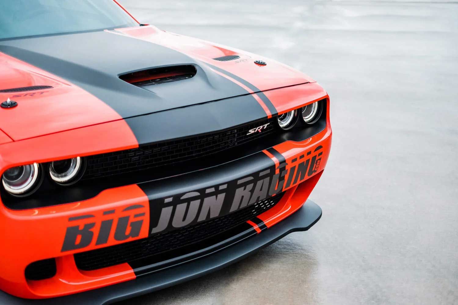 Orange and black Dodge Challenger with racing stripes, 