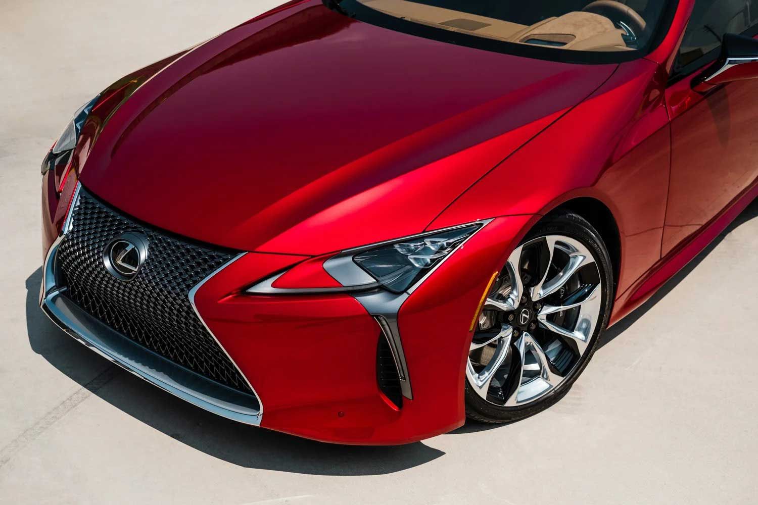 Red Lexus car, front view, shiny body, chrome grill and wheel, sunlight.