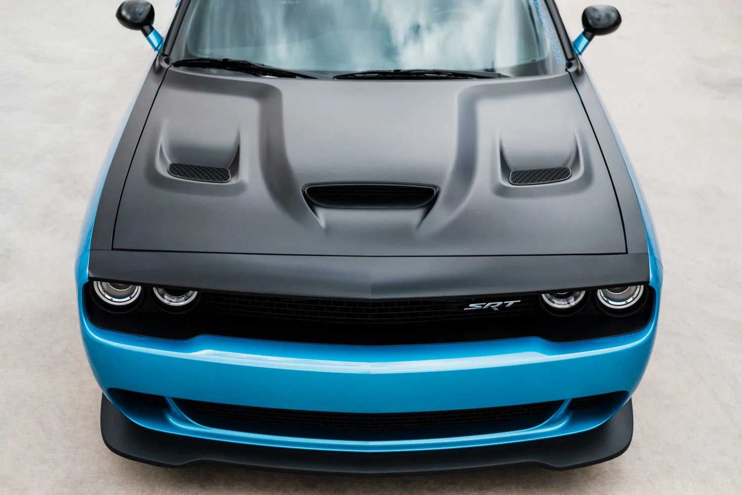 Blue Dodge Challenger with black hood and front spoiler.