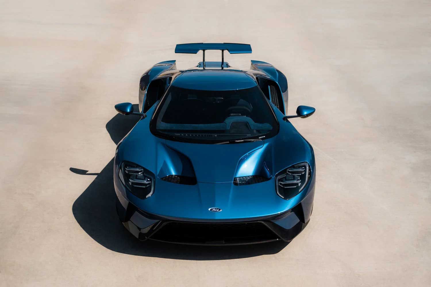Blue Ford GT sports car on a light-colored surface, viewed from above.