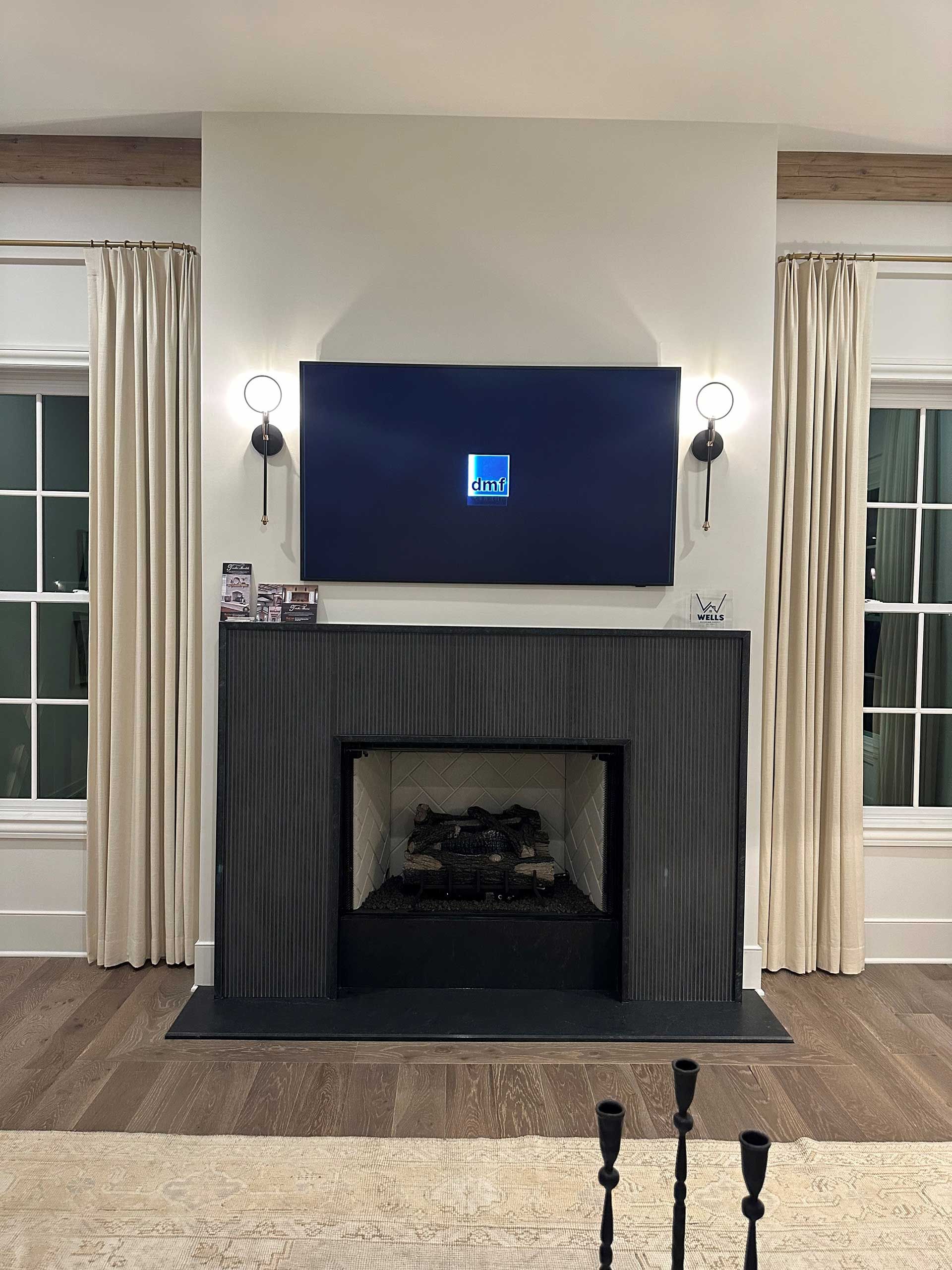 A living room with a fireplace and a flat screen tv above it