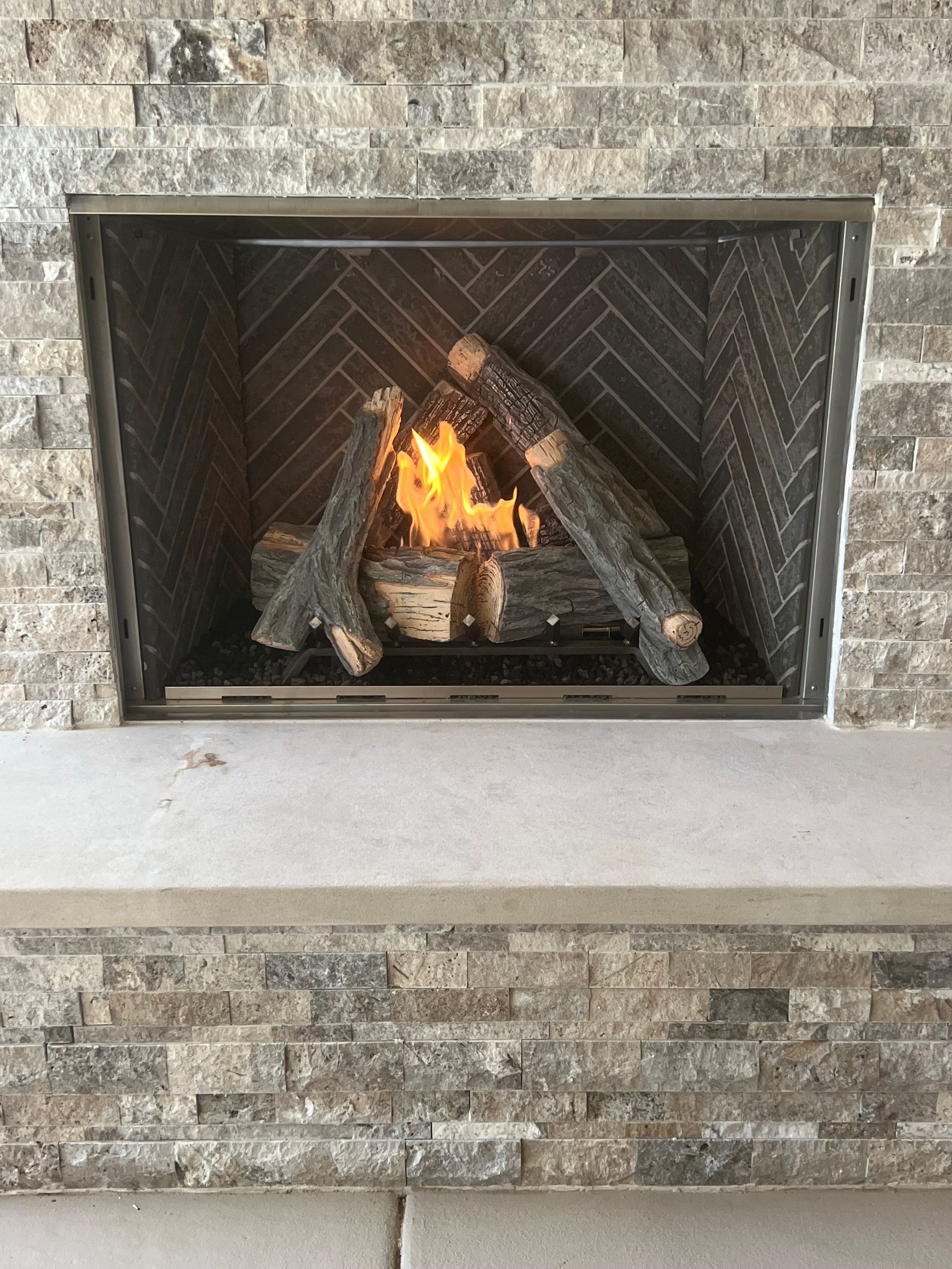 A fireplace with a lot of logs in it