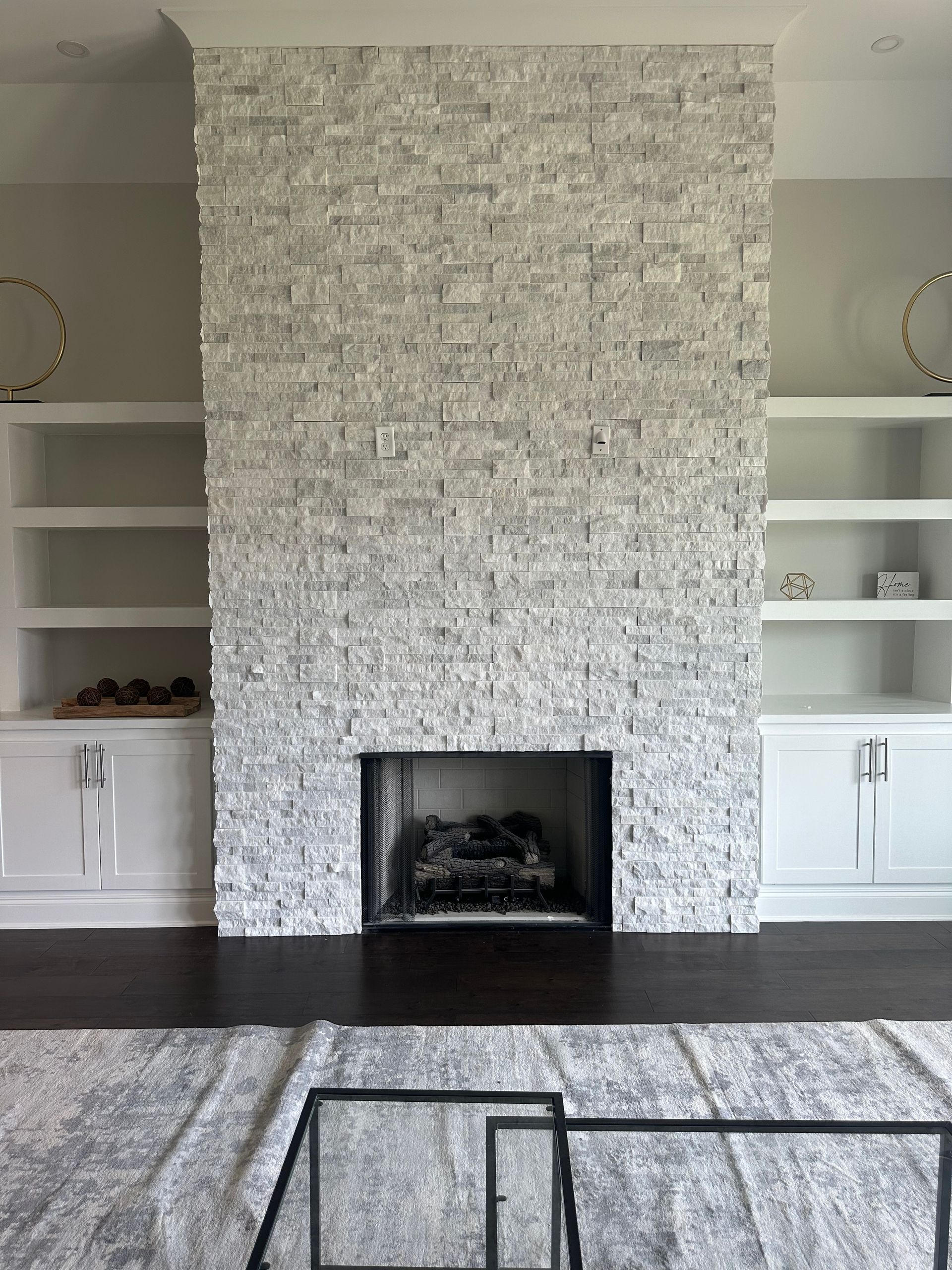 There is a fireplace in the middle of the living room.