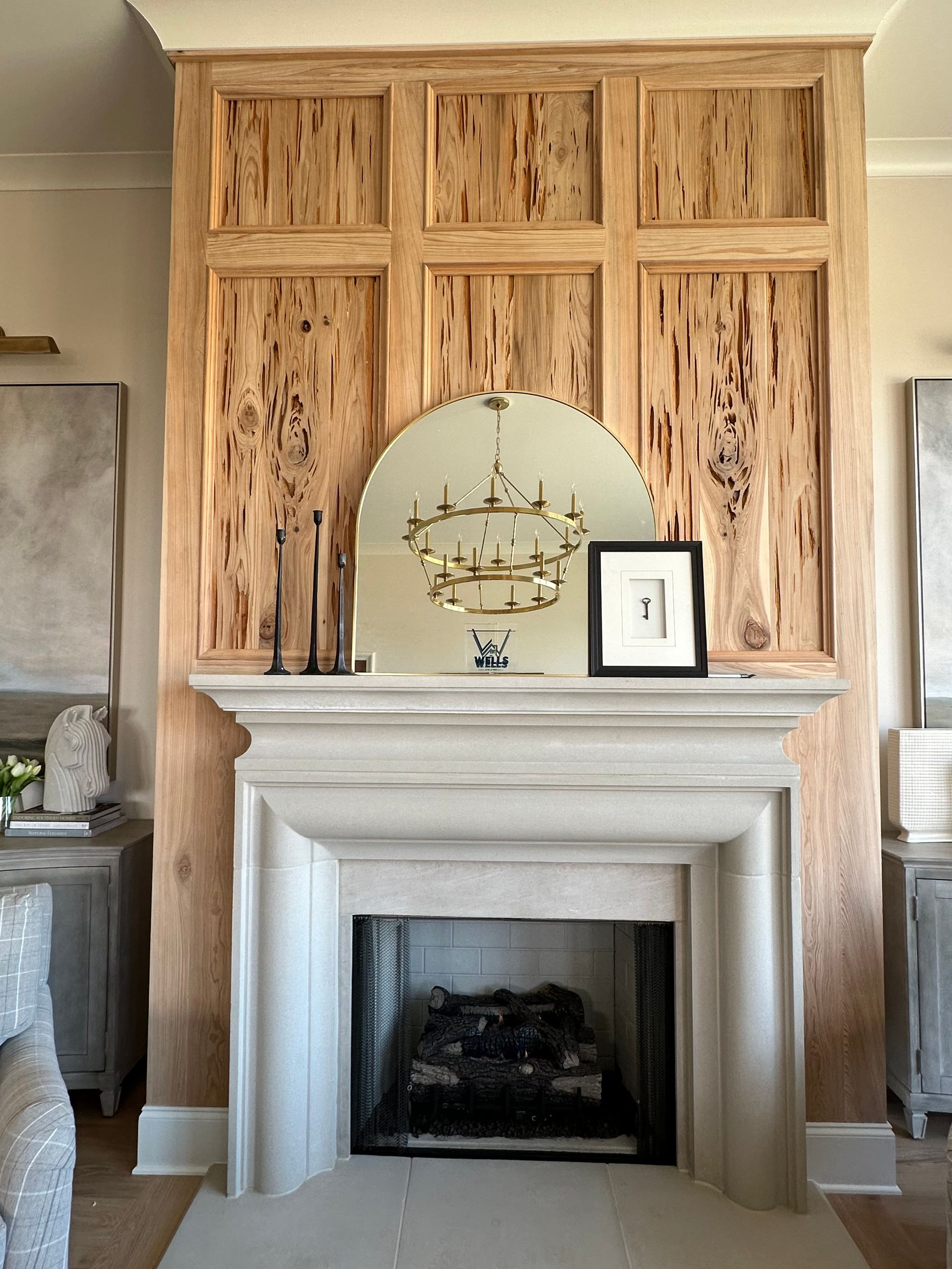 A fireplace in a living room with a mirror above it