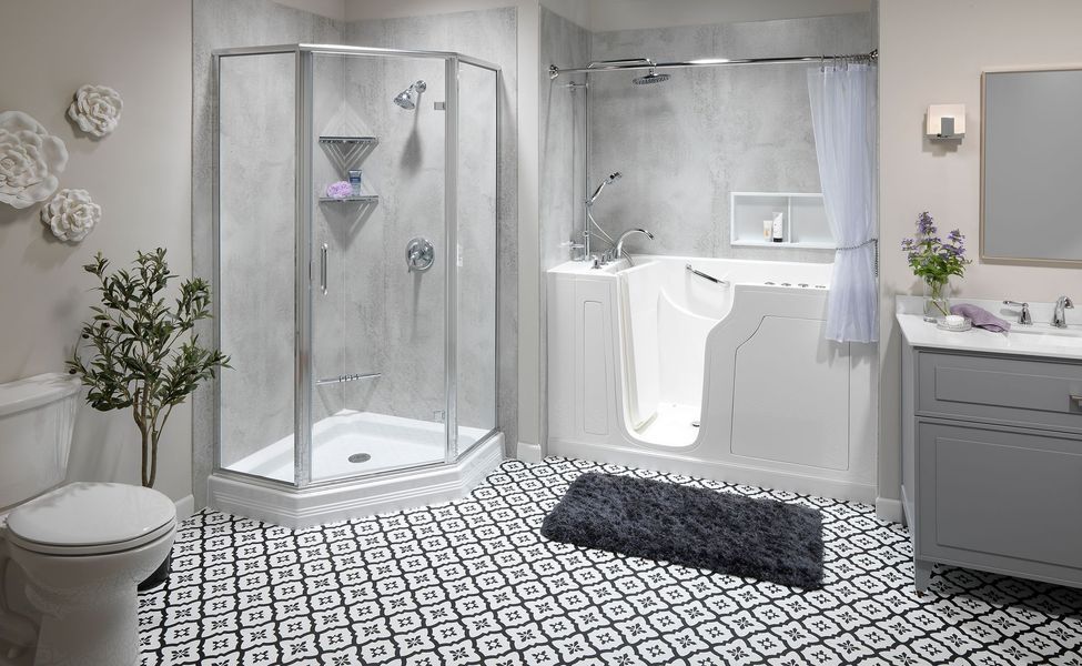 Bathroom with walk-in tub, corner shower, gray vanity, patterned floor, and a toilet.