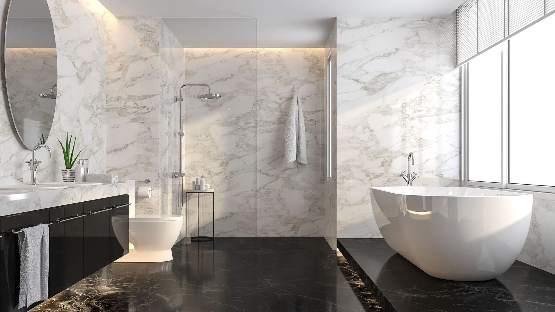 Modern bathroom with white marble walls, black floor, and white freestanding tub.