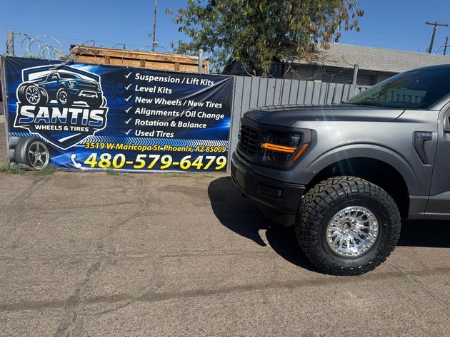 Black truck beside a banner advertising Sam’s Mobile Wash, with phone number 480-579-6479.