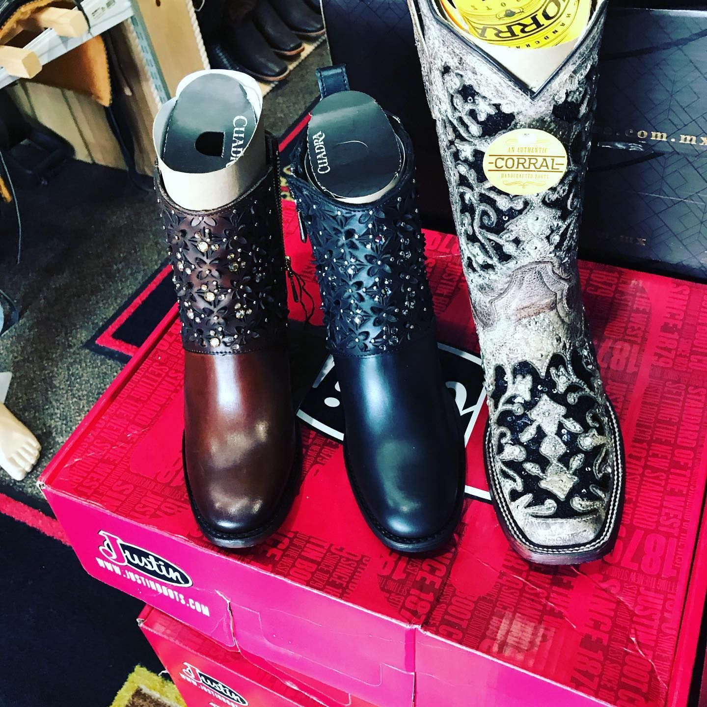 Three pairs of cowboy boots are stacked on top of each other