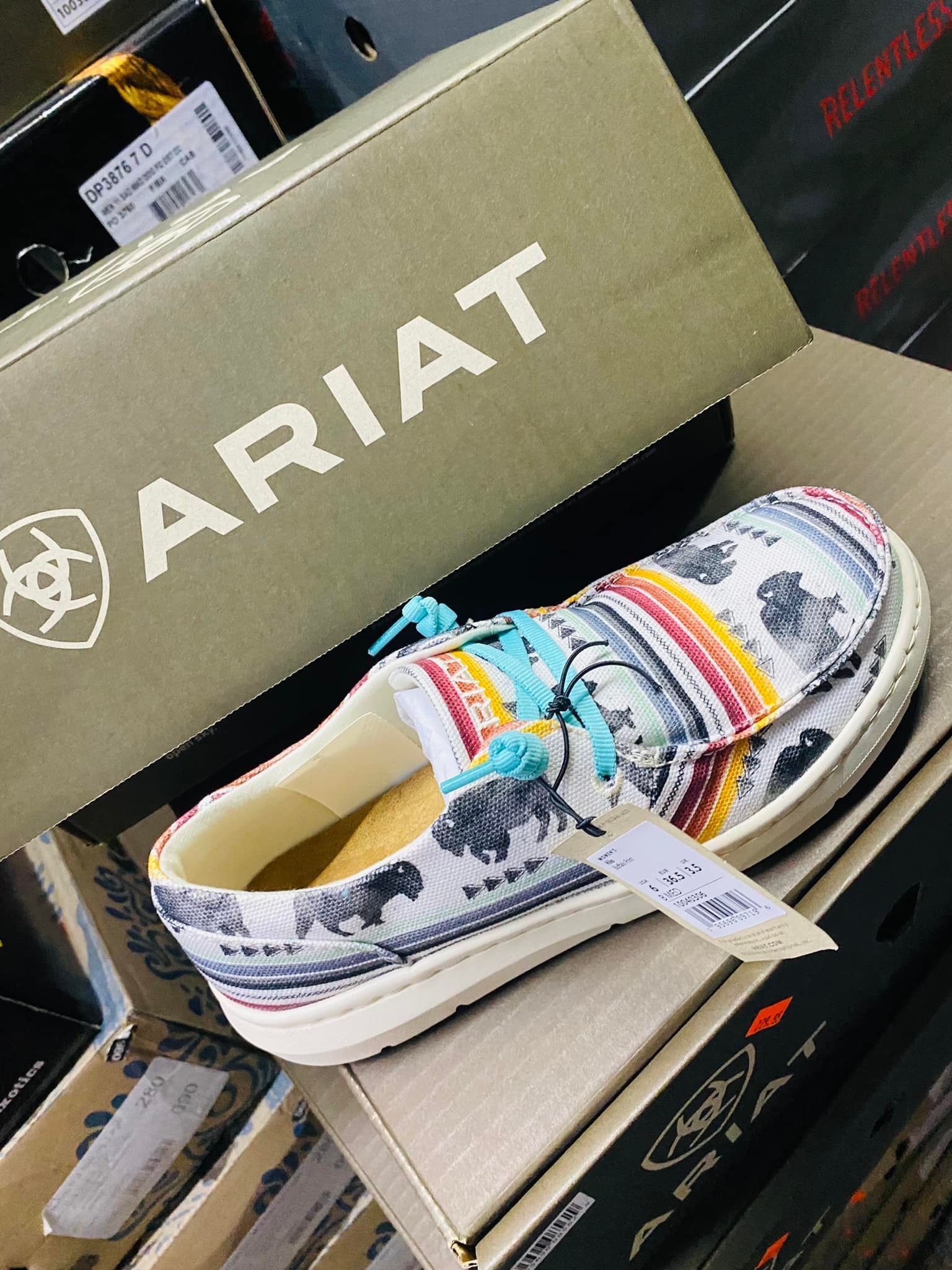 A pair of ariat shoes sitting on top of a box.