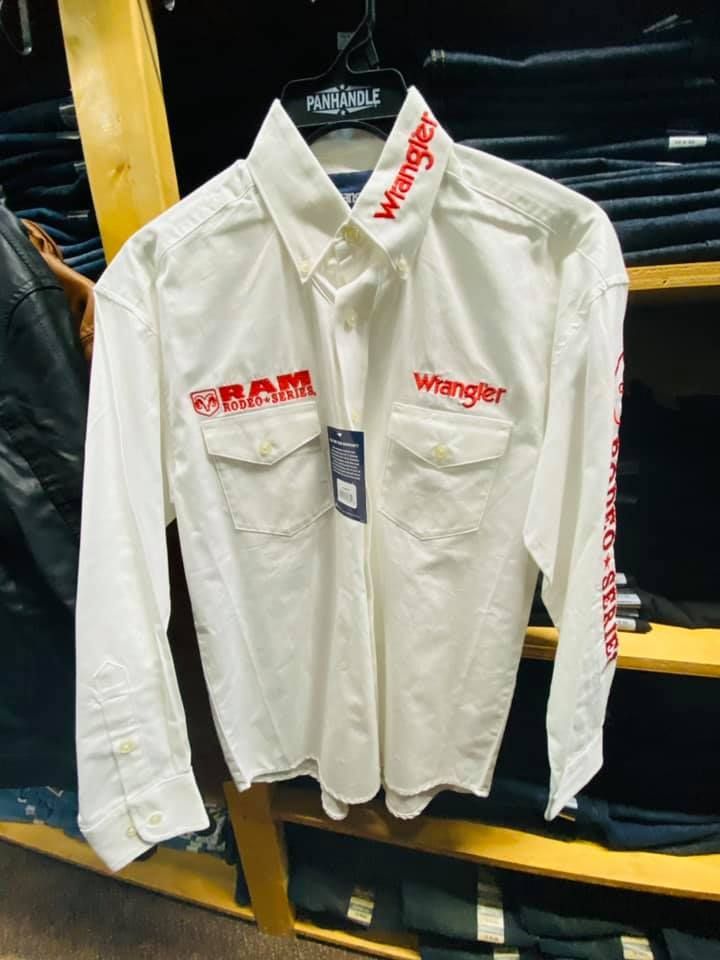 A white wrangler shirt is hanging on a hanger in a store.