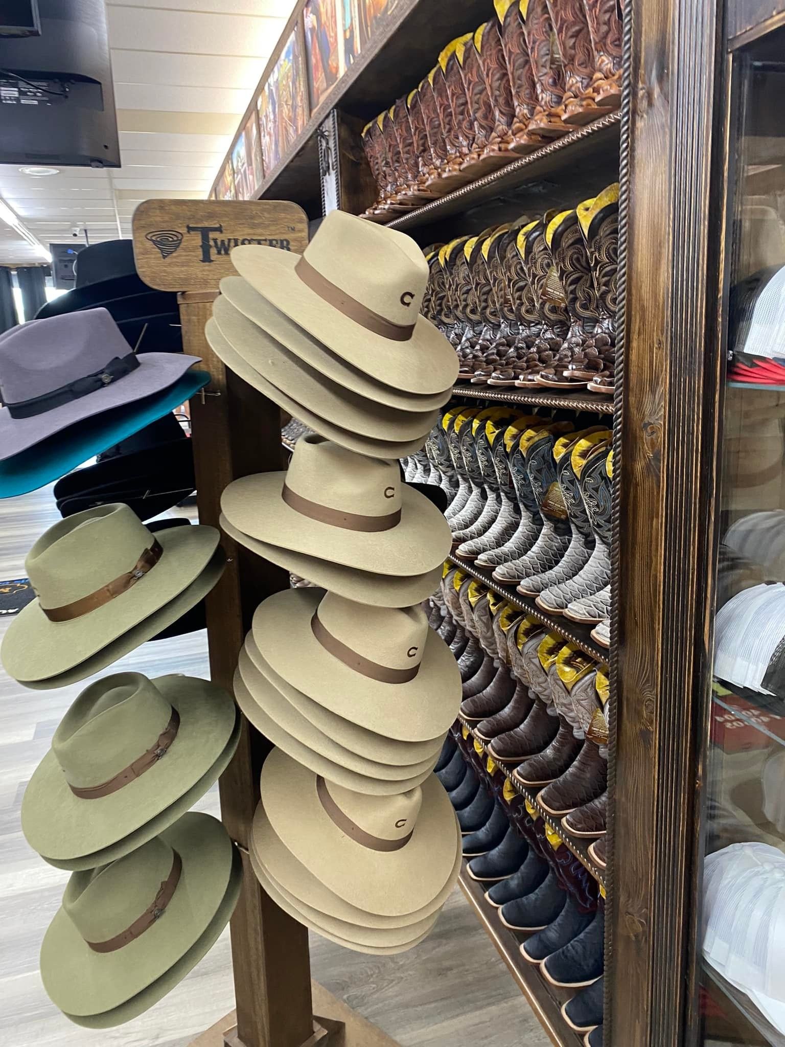 A display of cowboy hats and boots in a store.