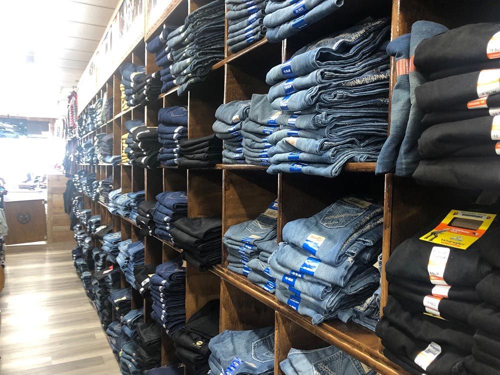 A store filled with lots of jeans and shirts.