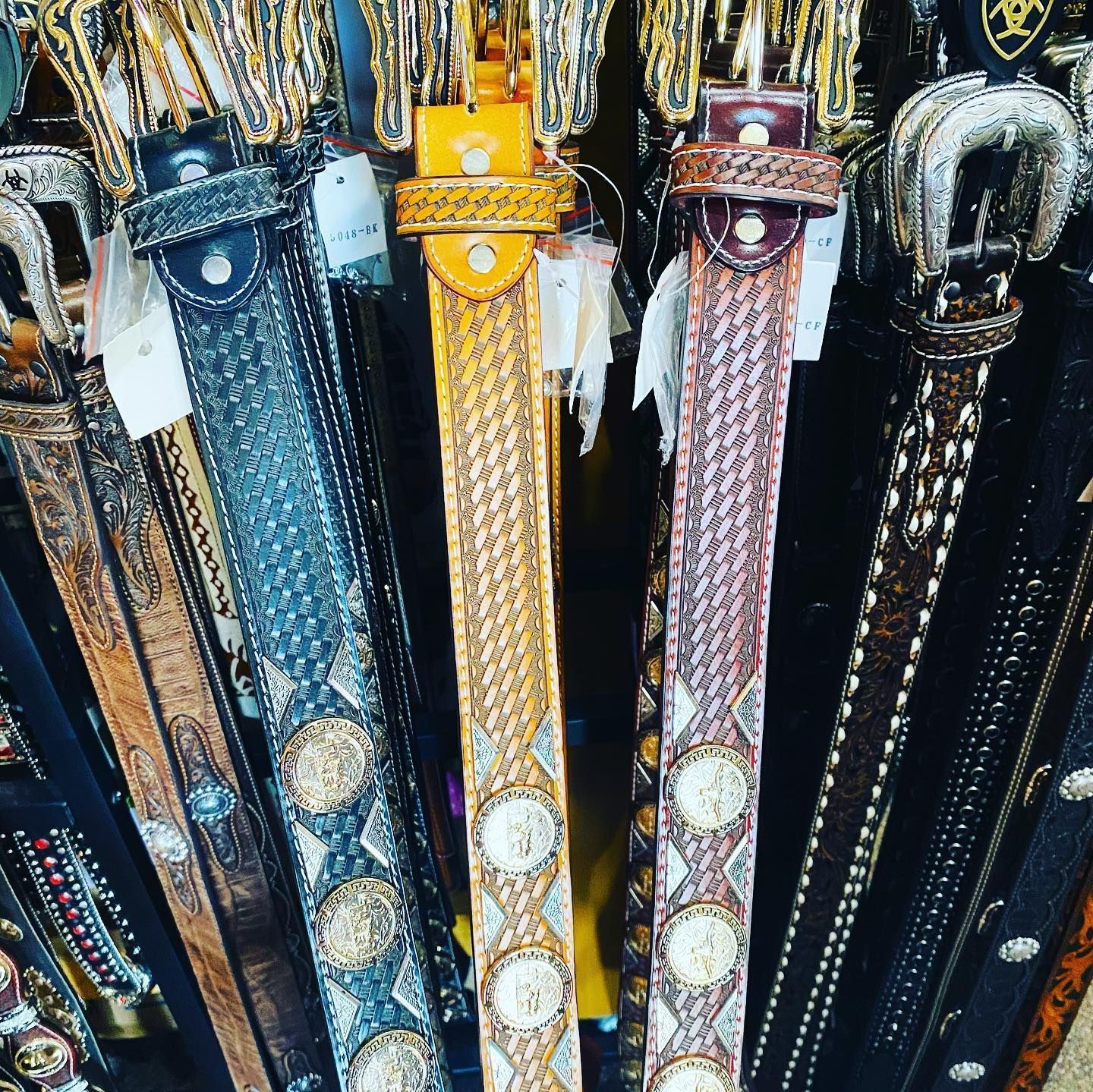 A bunch of belts are lined up in a row