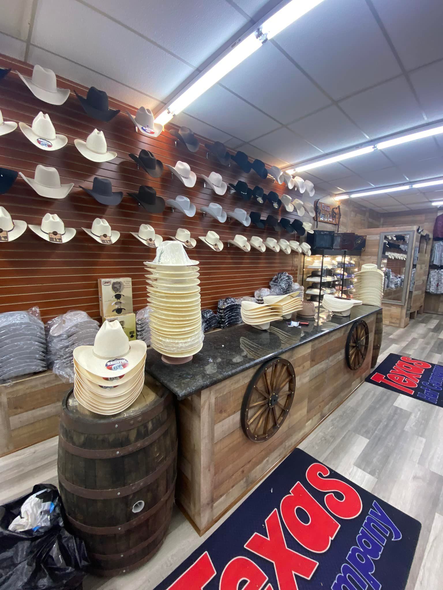 A store filled with lots of cowboy hats and barrels.