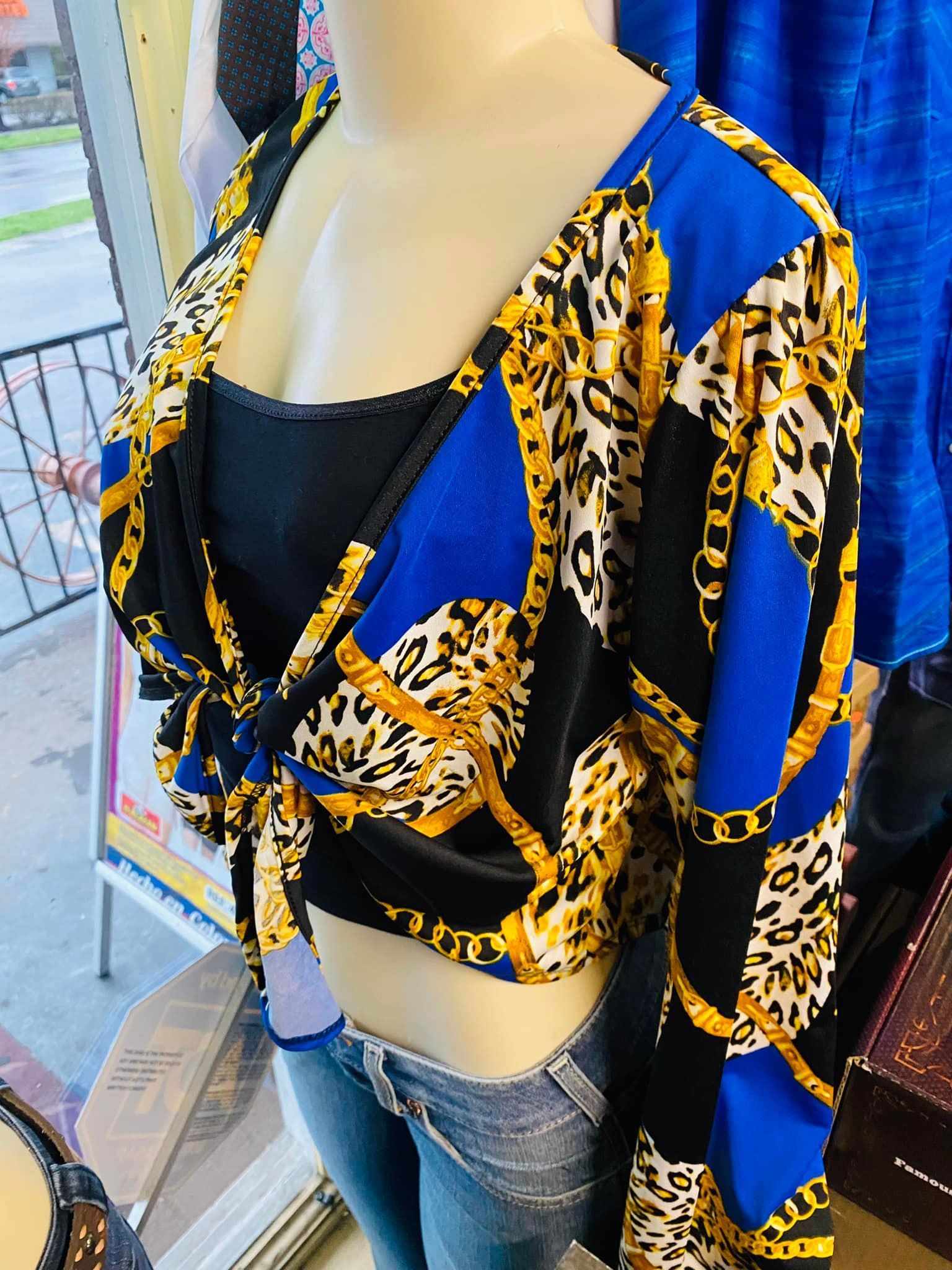 A mannequin is wearing a blue and gold leopard print top.