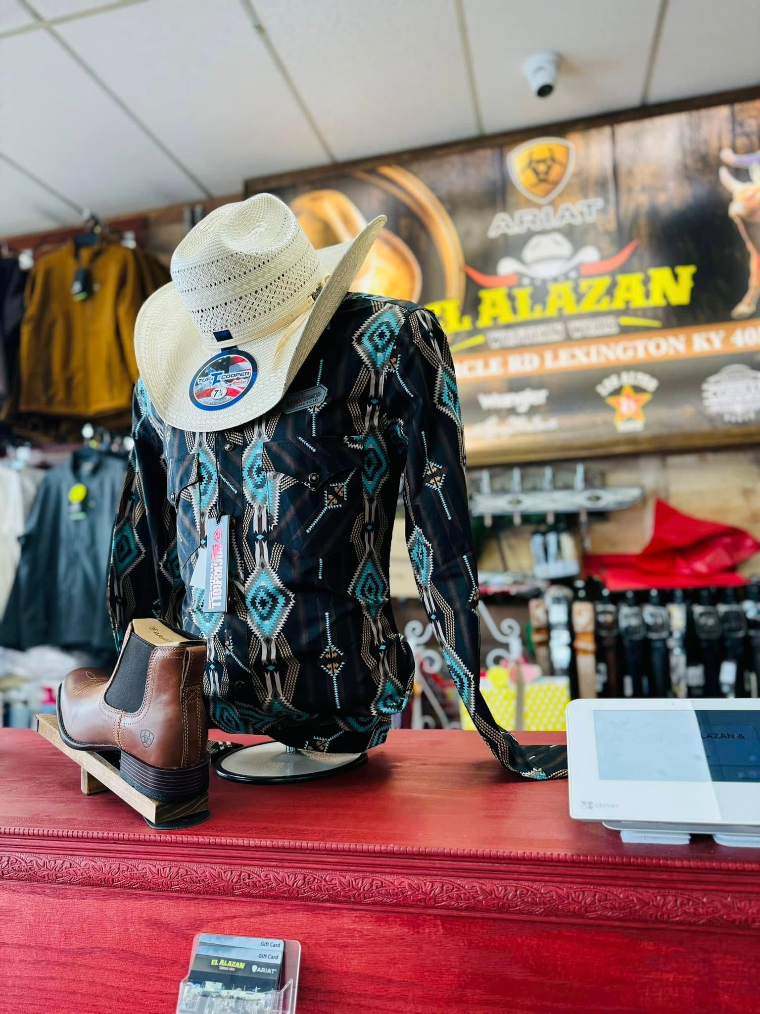 A cowboy hat is on a mannequin in a store.