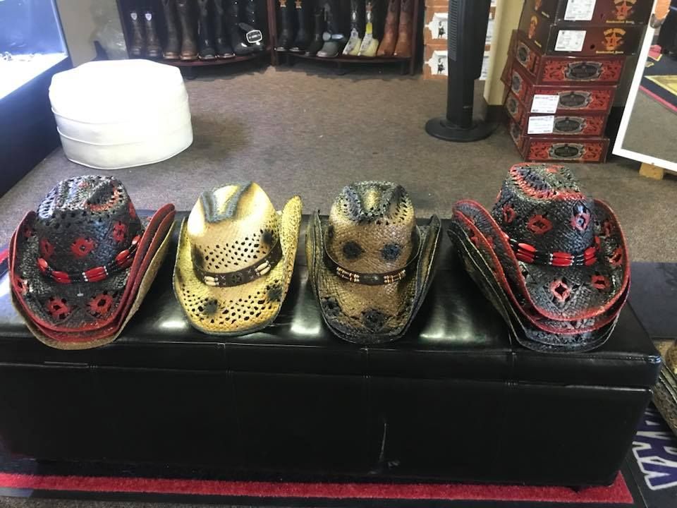 A row of cowboy hats are sitting on a bench in a store.