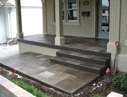 Front porch with steps and a low ramp, showing an accessible entrance to a house