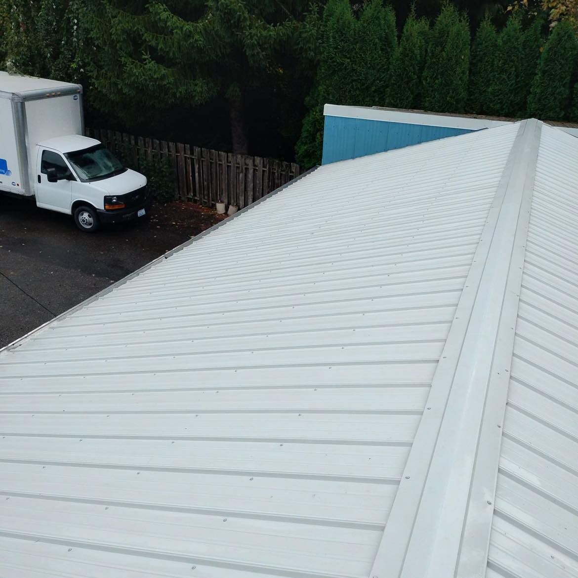 a white truck is parked on the roof of a building