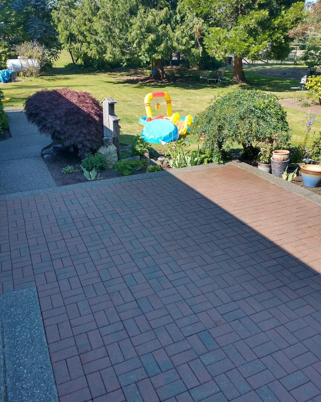 a brick patio with a pool float in the middle of it