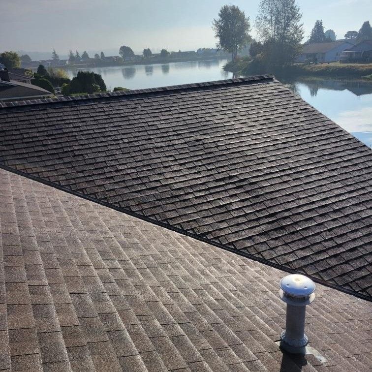 the roof of a house with a view of a lake