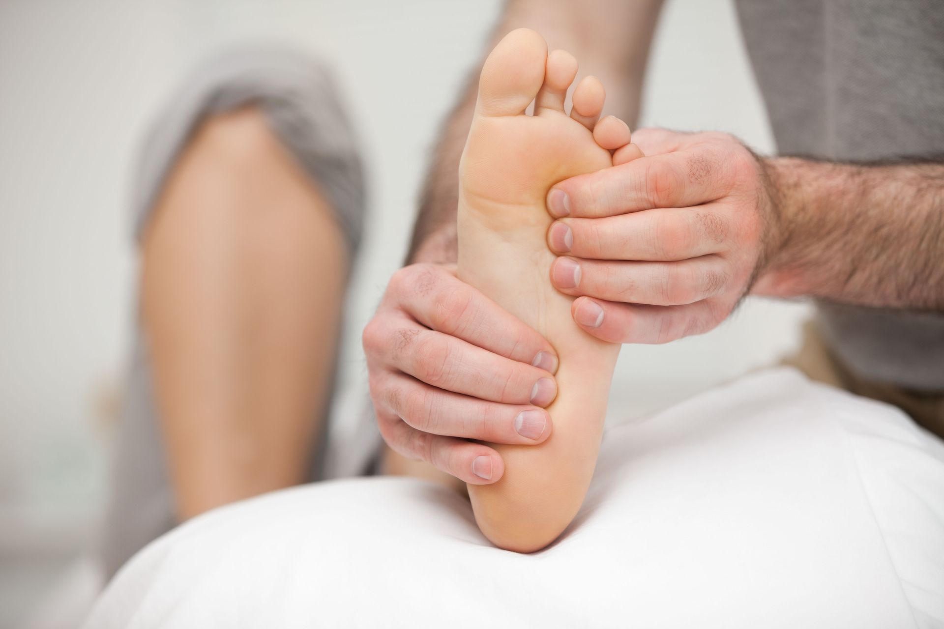 A man is giving a foot massage to a woman.