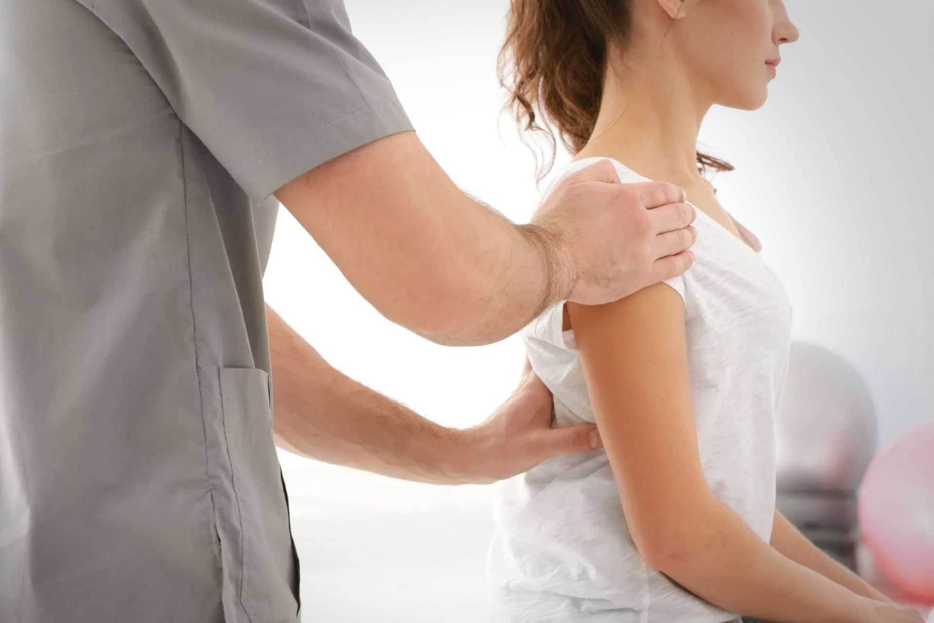 A man is giving a woman a massage on her back.