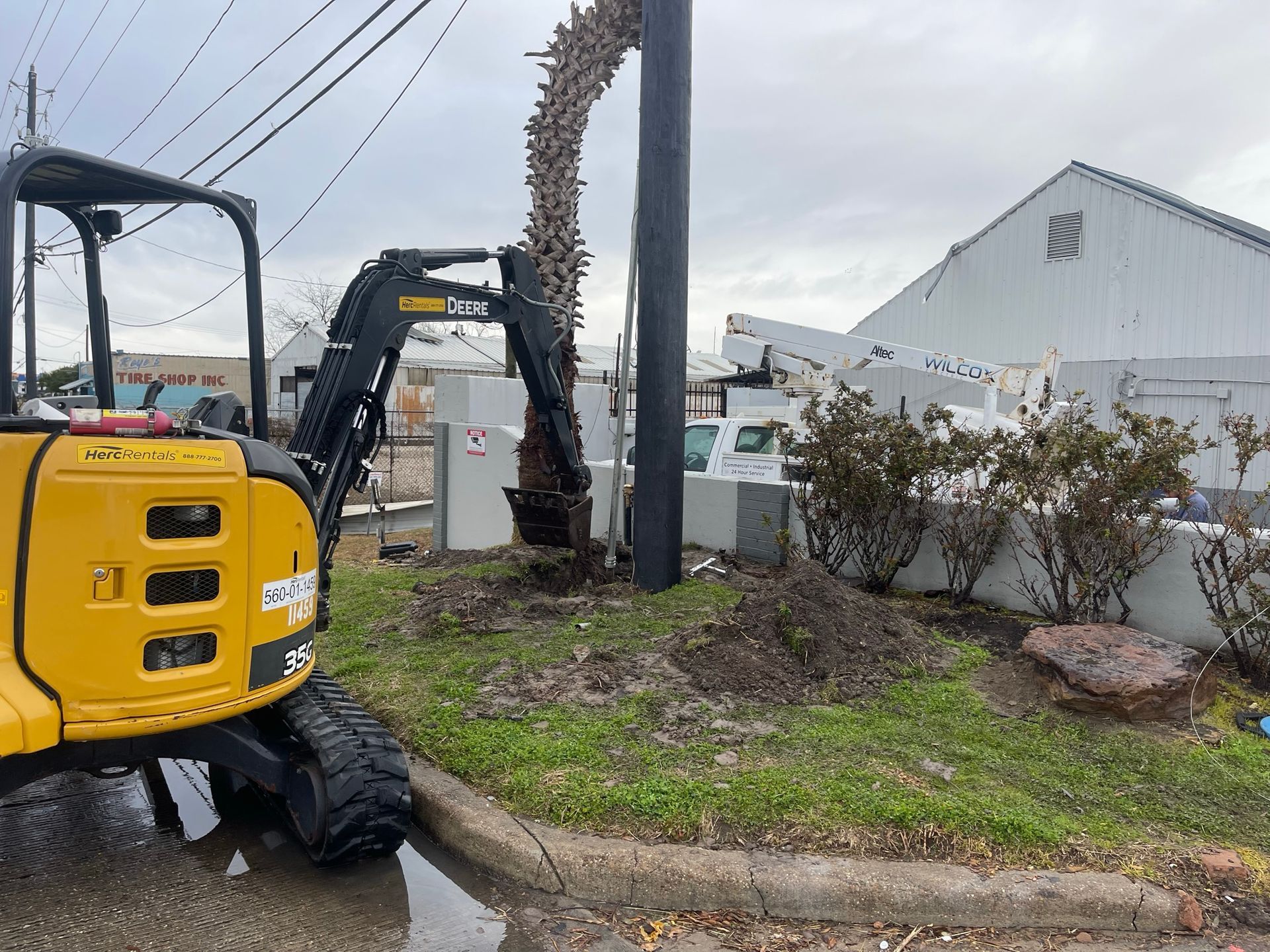 Excavator digging near an electrical post