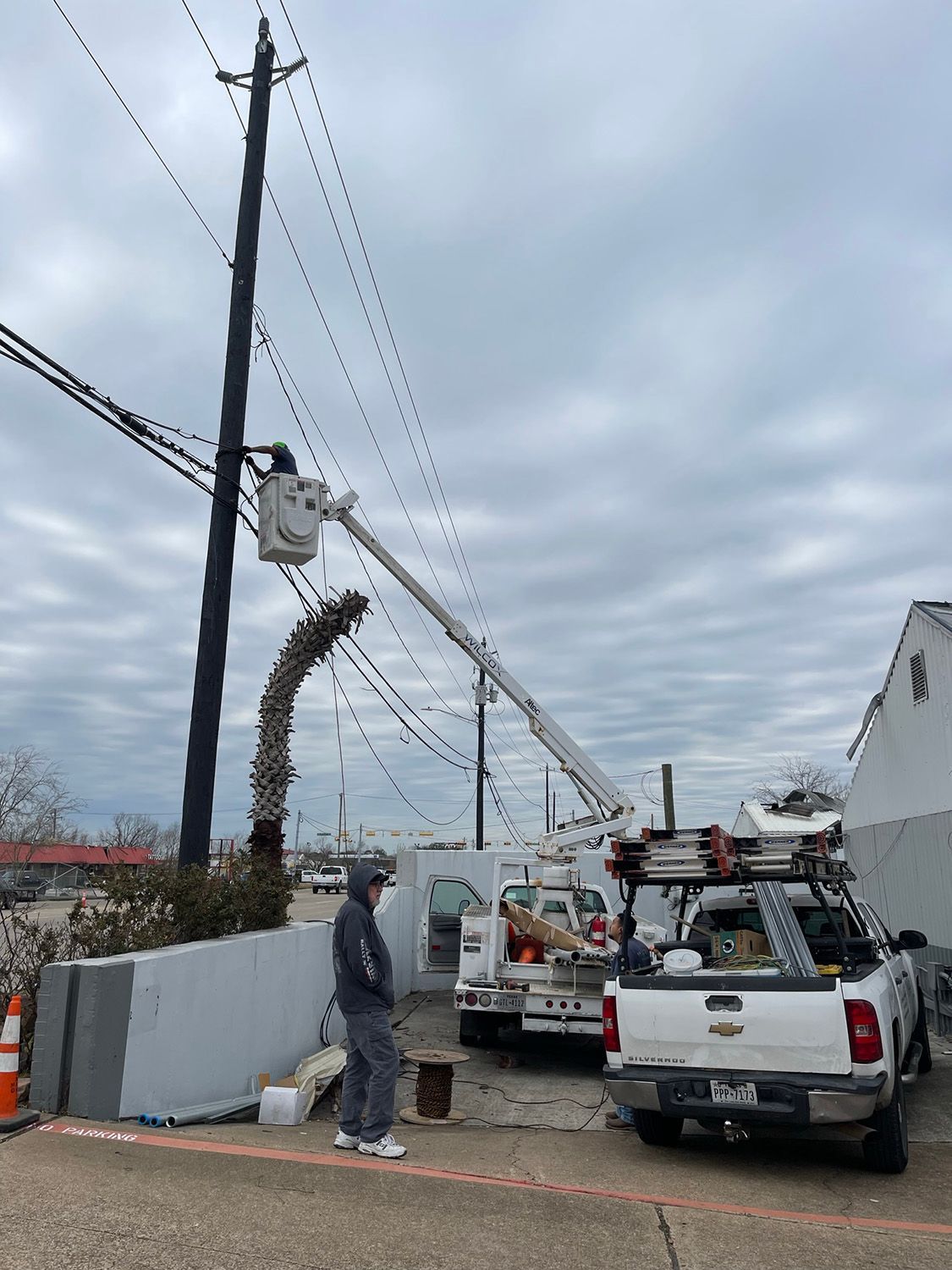 Man on a bucket truck fixing an electrical post