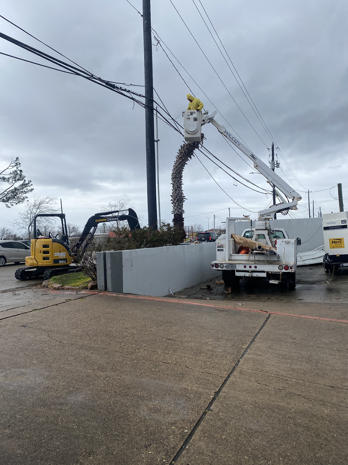 Man on a bucket truck fixing an electrical post accident