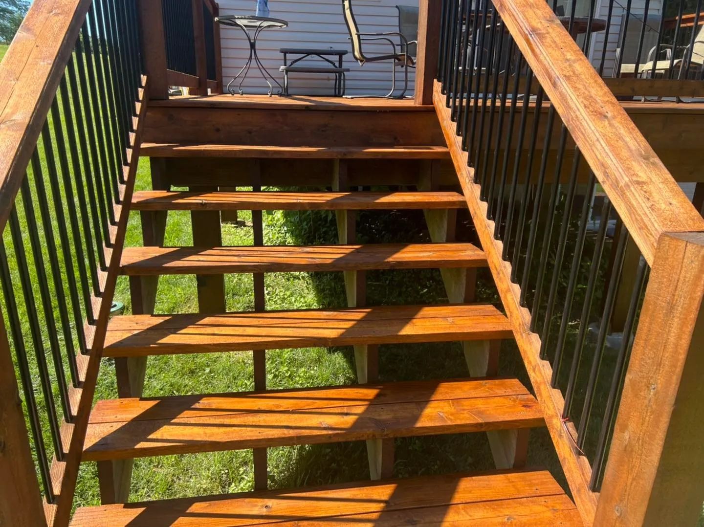 A wooden deck with a ramp leading to a house.