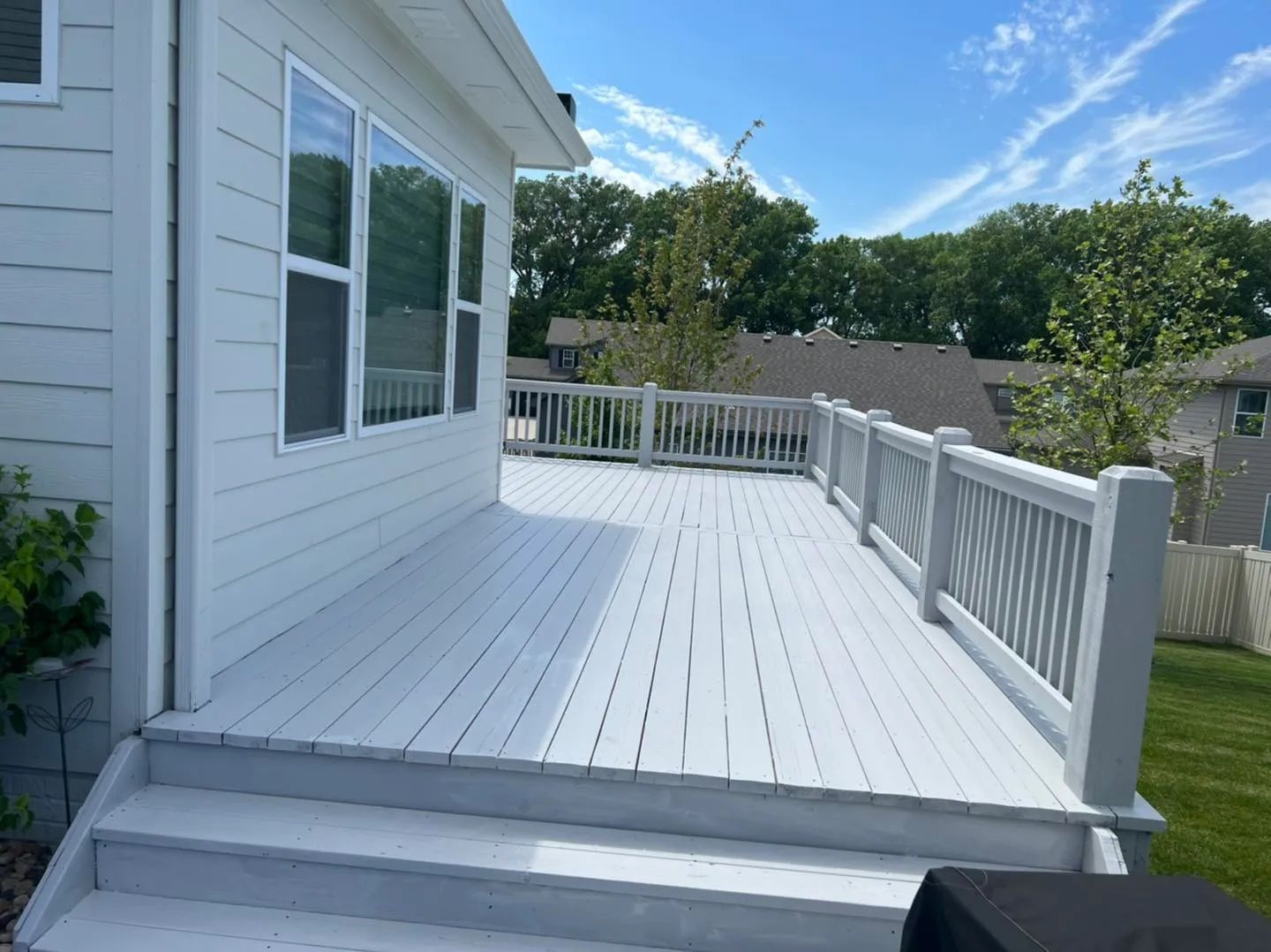 An aerial view of a wooden deck in a backyard.