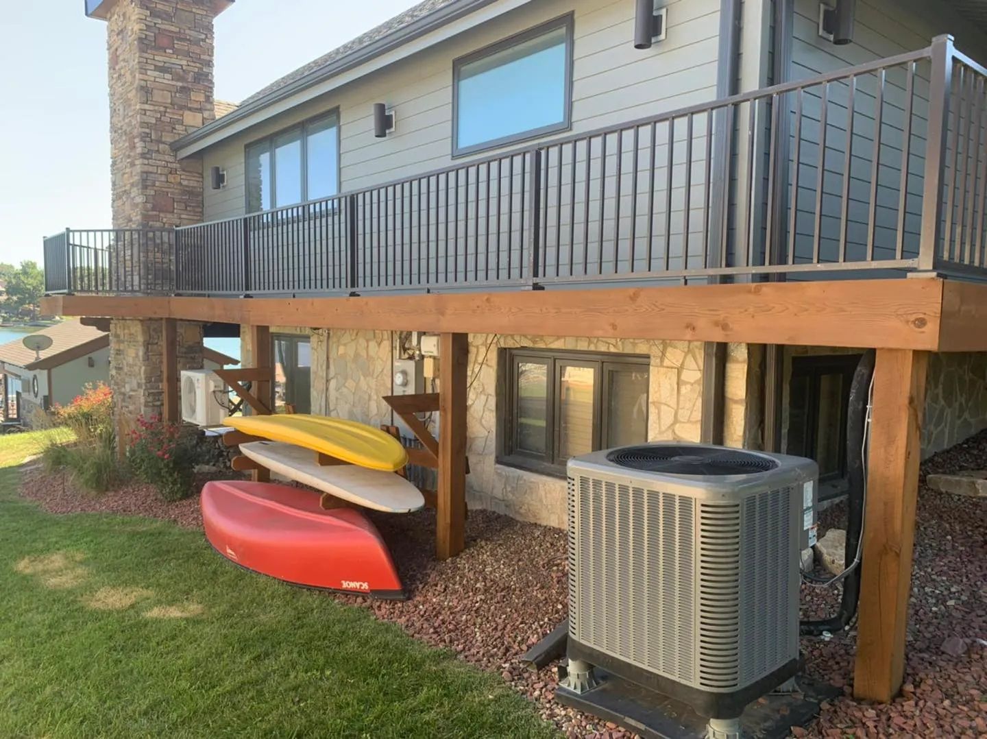 A red deck with a red fence in front of a house.