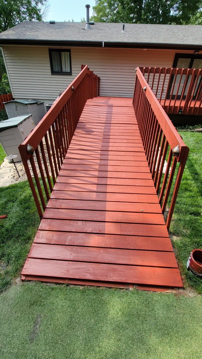 A wooden deck with stairs leading up to it