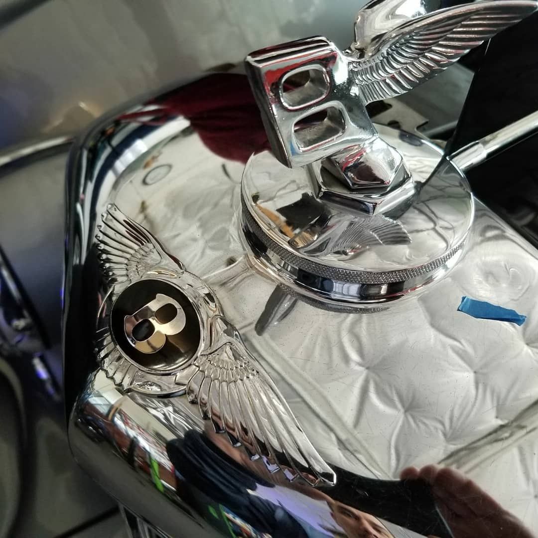 A bentley emblem is on the side of a car