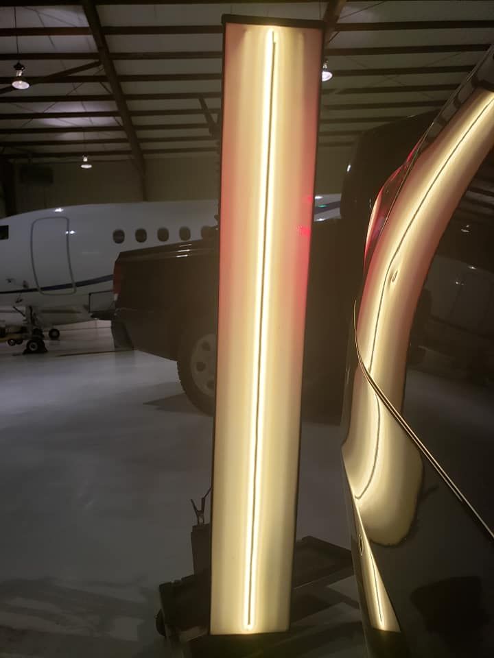 A light is shining on a car in a garage