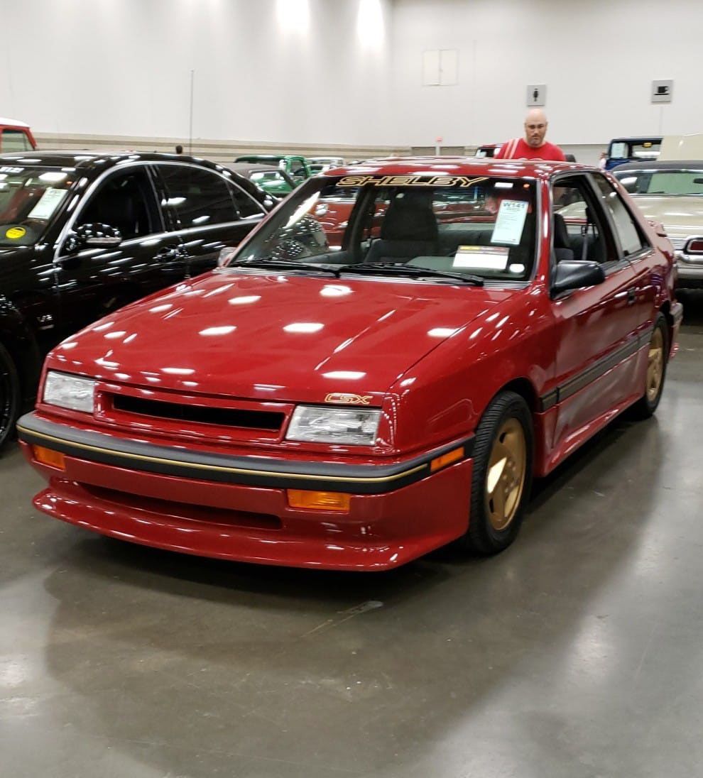 A red car is parked next to a black car