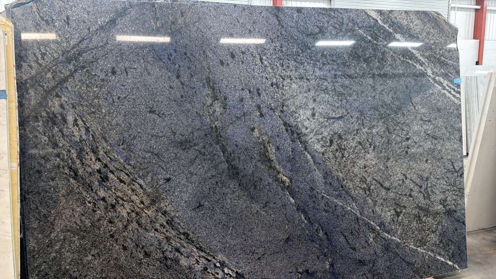 Large gray-black granite slab with dark veining and polished surface patterns